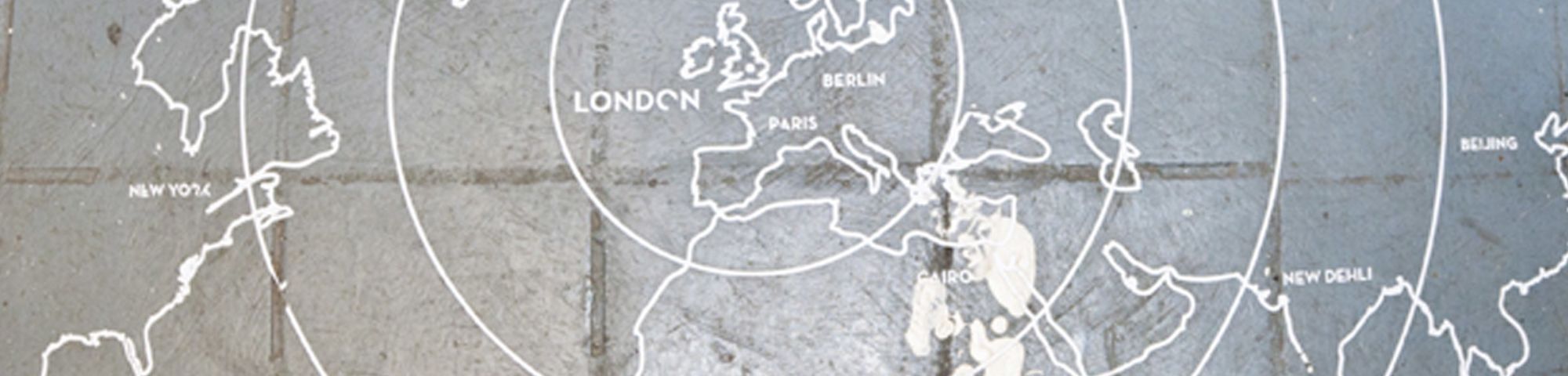 A map of Europe and other continents drawn on a cobbled floor