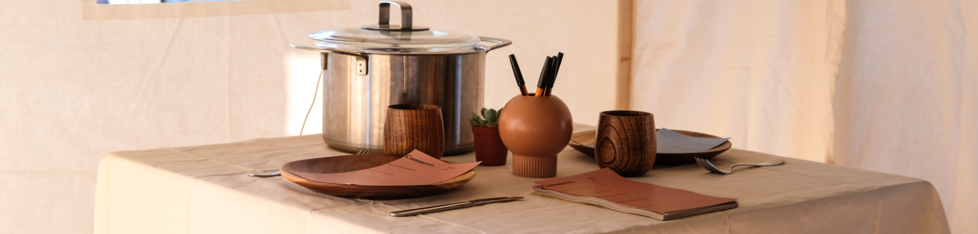 A table with plates and a cooking pot