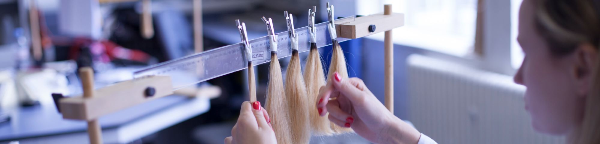 Close up of strands of blonde hair in a lab