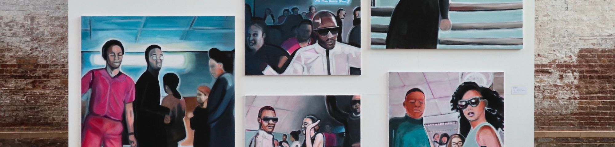 Paintings of people hanging on white wall