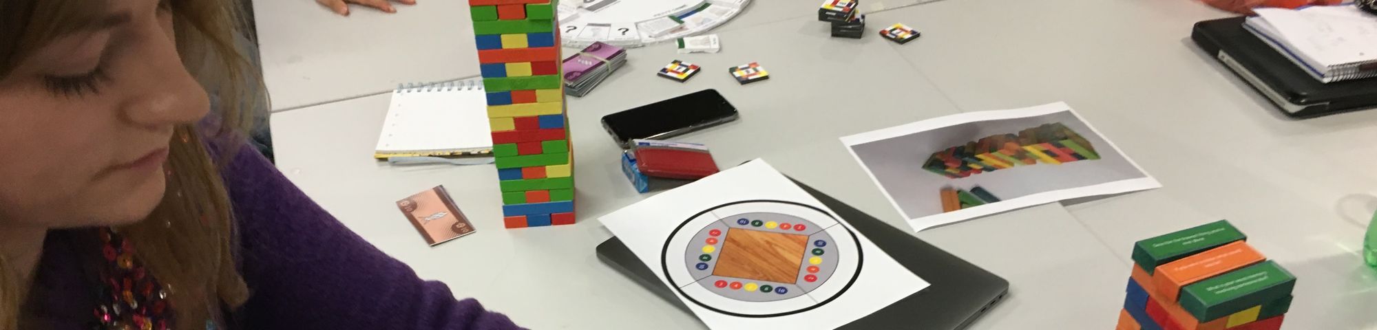 People sitting with coloured blocks on table