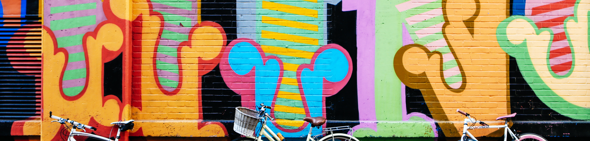 Bikes in front of graffiti