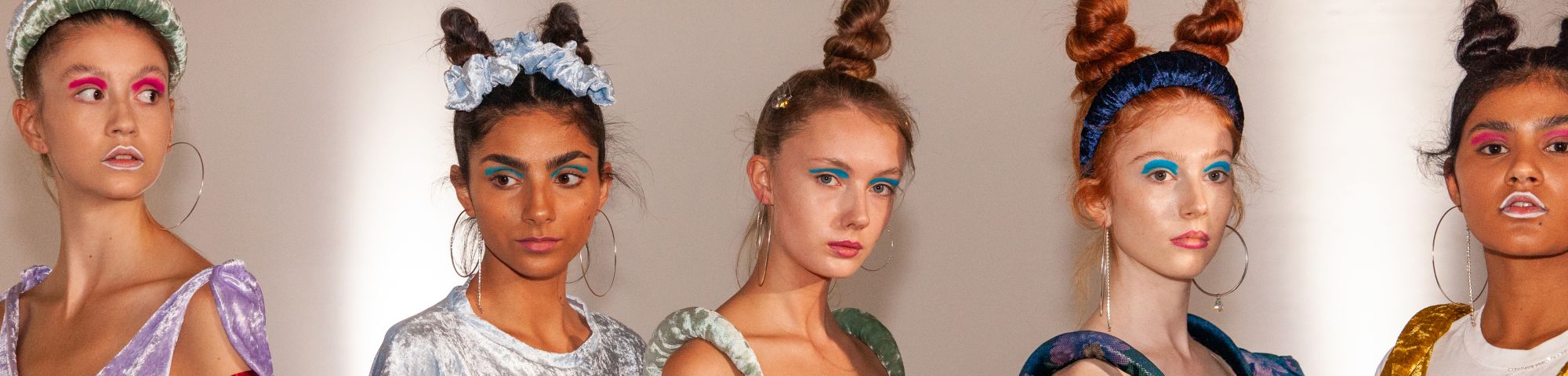 Female models posing with colourful clothes and makeup