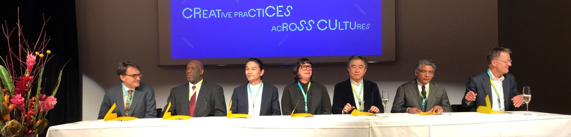 Panel of signatories at a table