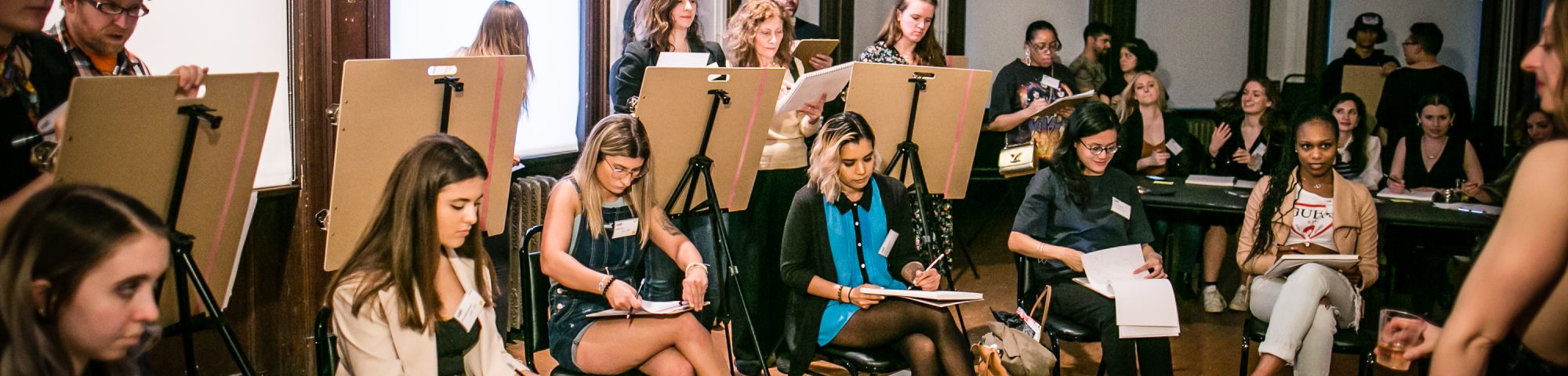 People taking part in a life drawing class