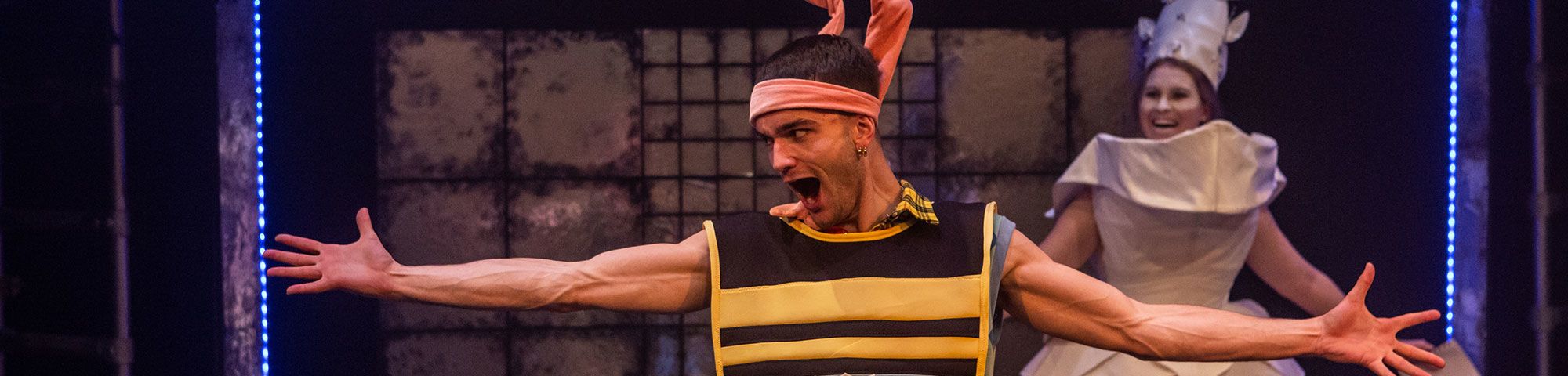Actor wearing pink bunny ears with his arms outstretched.