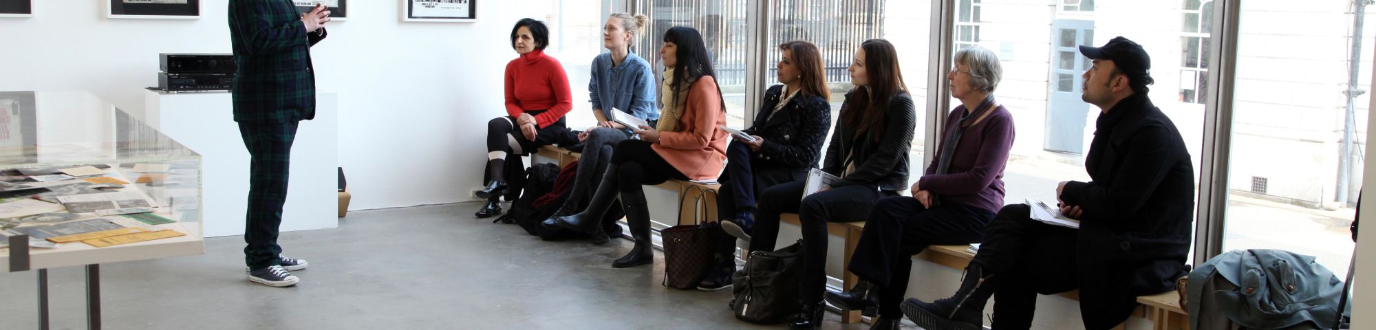Students discussing a show inside a gallery