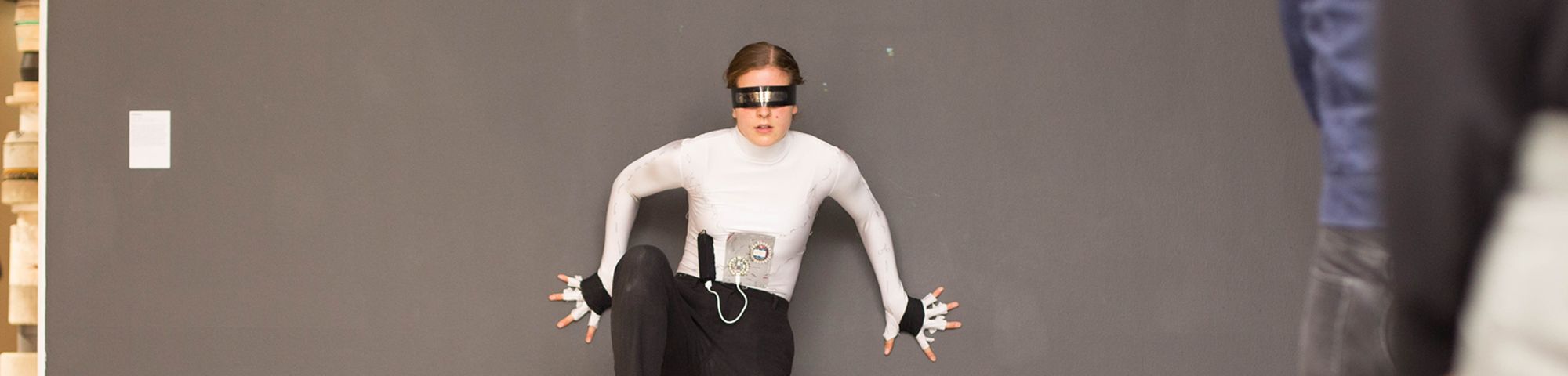 Woman in a gallery space doing a performance