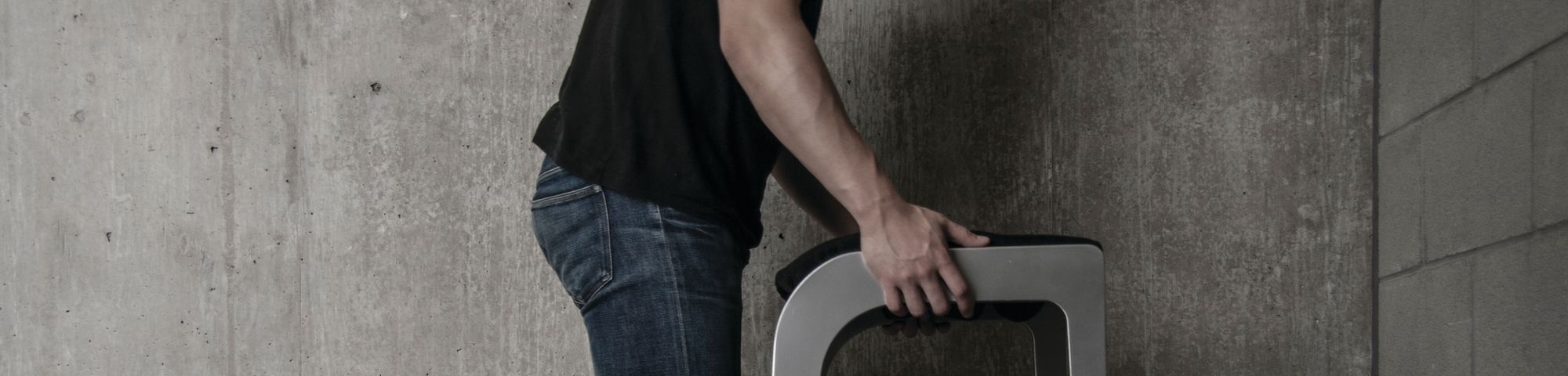 Man holding furniture over toilet