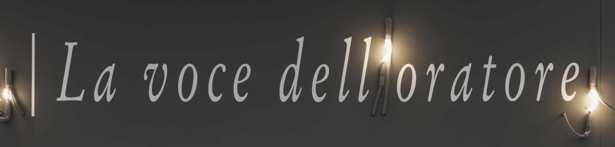 A piece of white text against a black wall