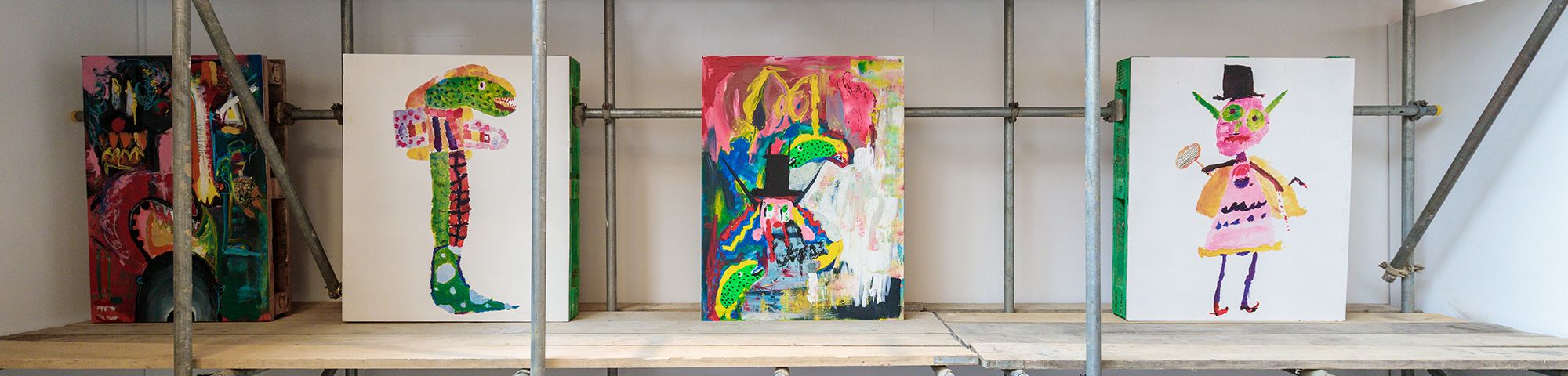 7 paintings displayed on scaffolding
