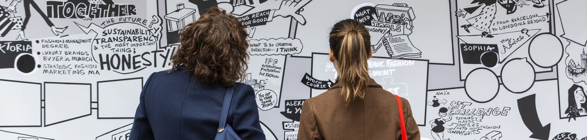 Two people staring at a graffiti