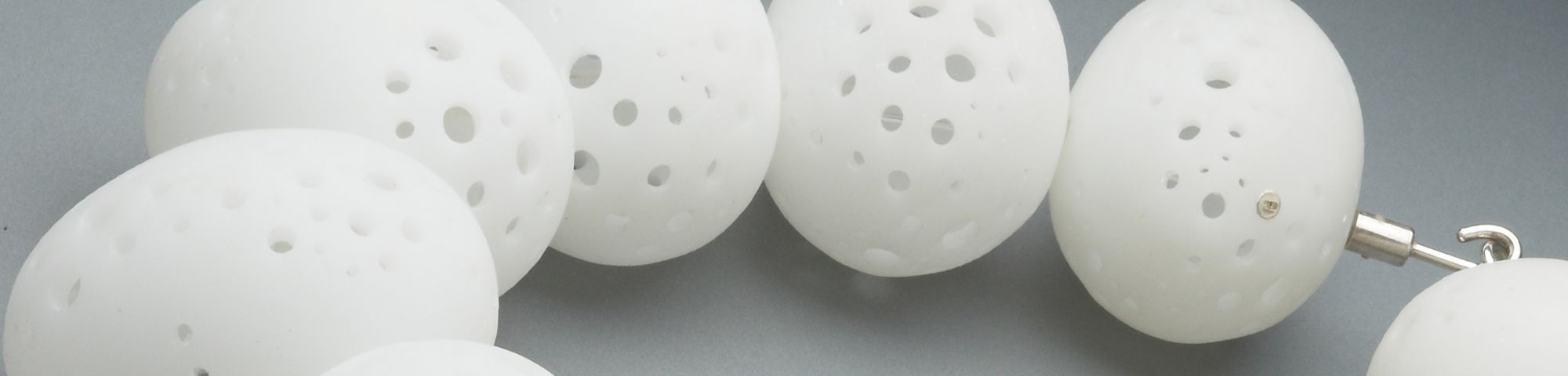 Sarah King's jewellery design, egg shaped balls with holes necklace.