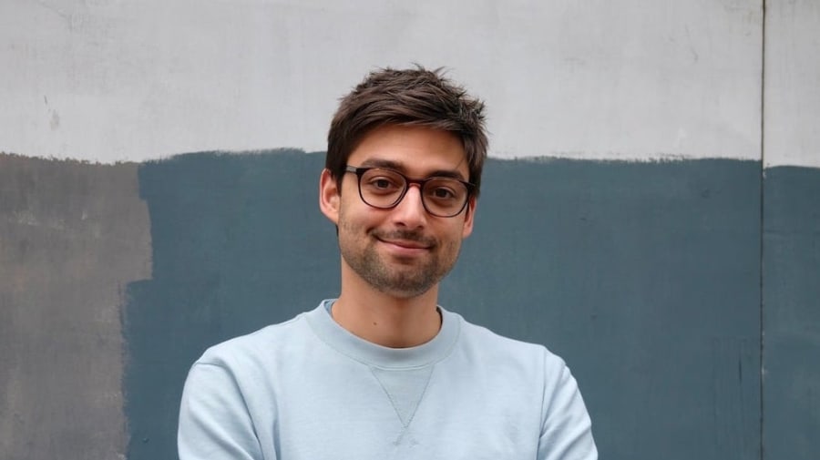 man wearing glasses with arms folded