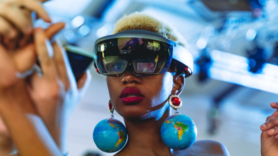 Girl wearing futuristic glasses and globe earrings