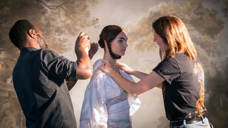 A mand and a woman fixing the hair and clothes of a female model. School of Media and Communication BA19 Exhibition, ©Arianna Poverini