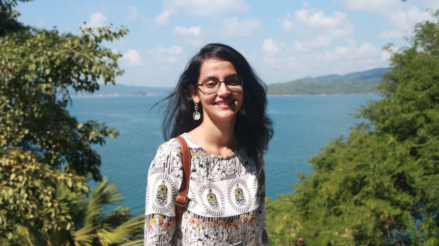 Image of UAL student Trisha Rathod in front of a sea view