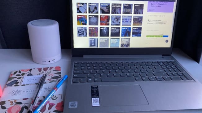 A UAL student laptop, notebook and pens, ready for online learning