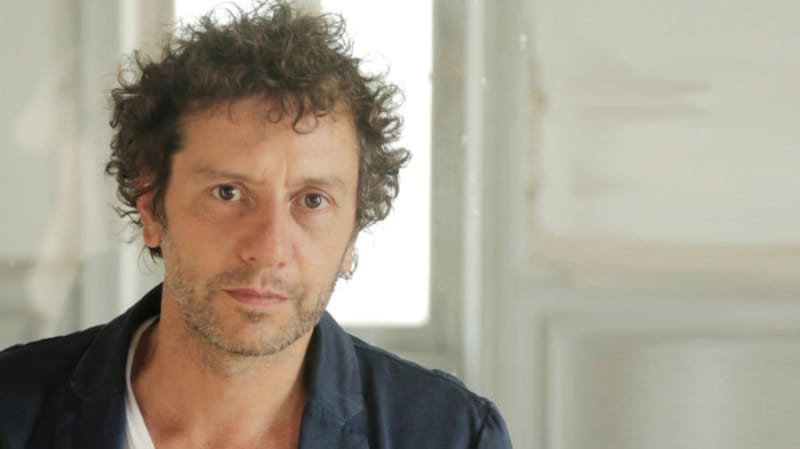 photo of man in his 40s wearing white shirt and a blazer