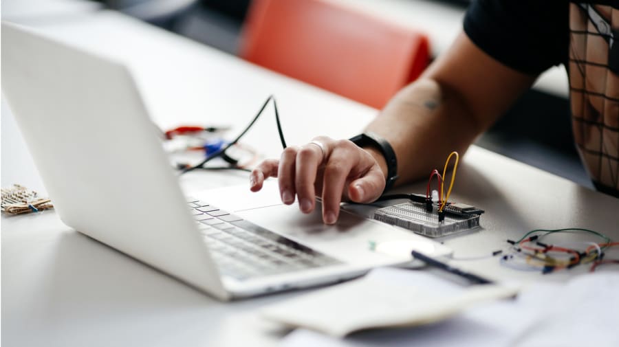 A close up image of Finn Weaver's hand on their laptop
