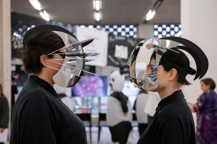 Two people wearing masks