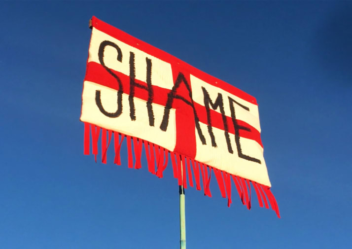 Flag of St George's Cross with 'Shame' written across