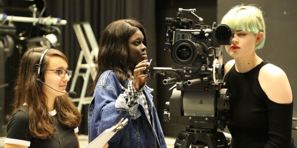 Three women project manage a film-shoot.