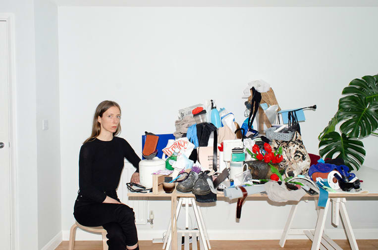 Figure sitting next to table covered with waste