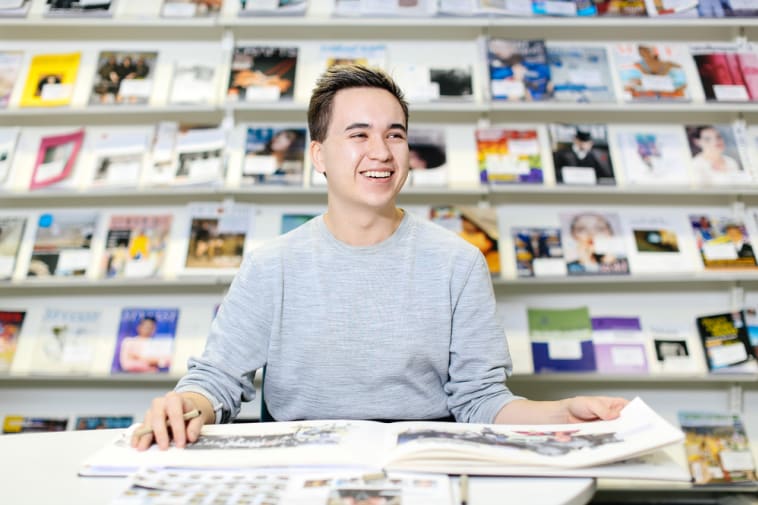 Student laughing in library