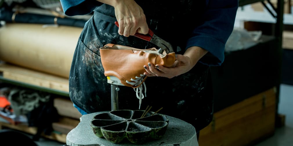 Niki making leather shoes in her workshop