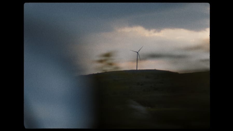 A landscape featuring a windmill.