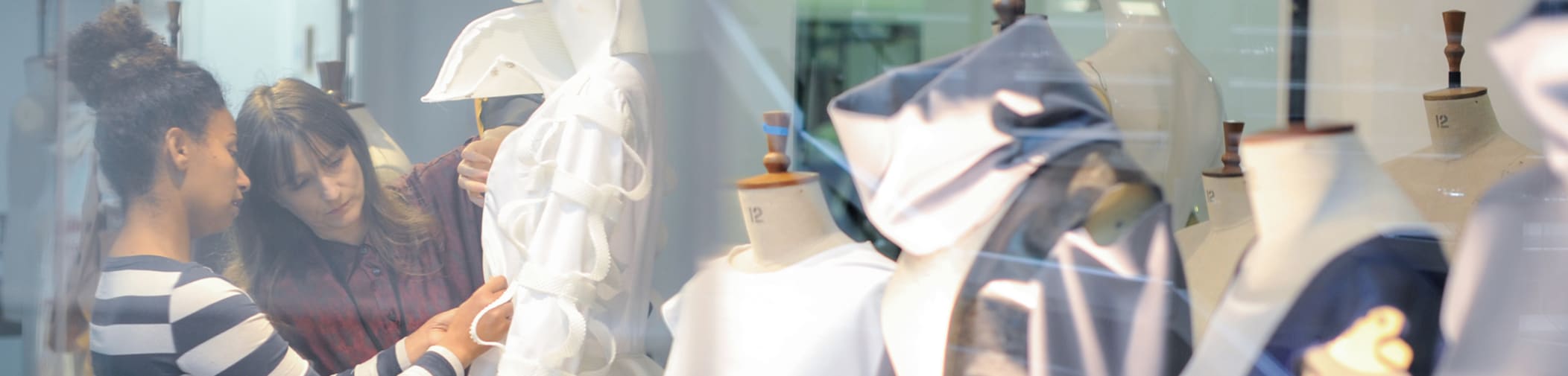 A student and tutor preparing a window display