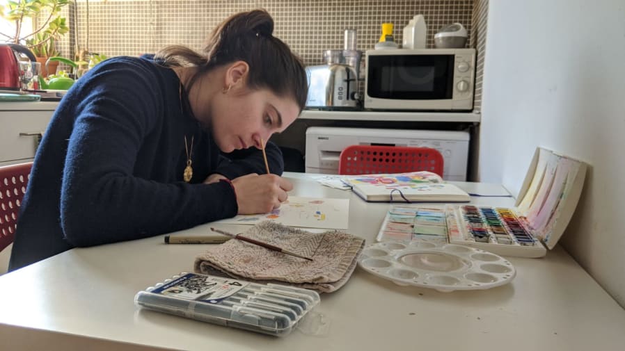 student working on kitchen table