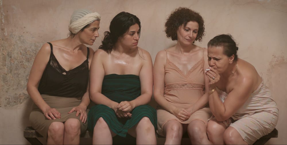 A film still of women in a public bath.