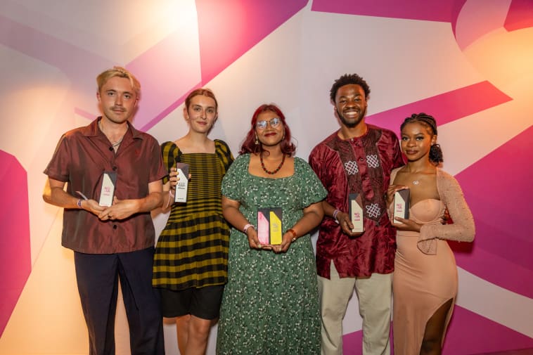 A group shot of the five winners with their awards and NOVA branding behind them