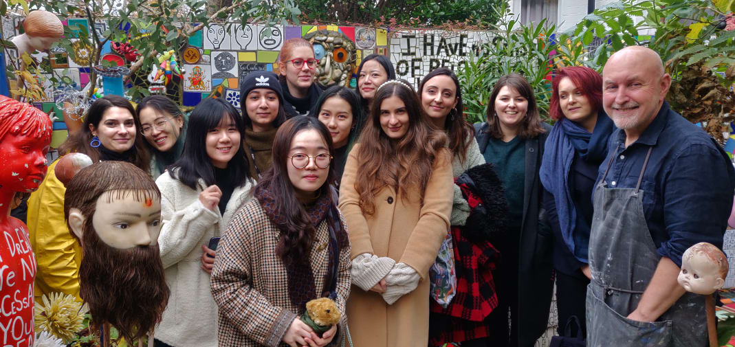 Group shot in the garden of the house with the owner and students