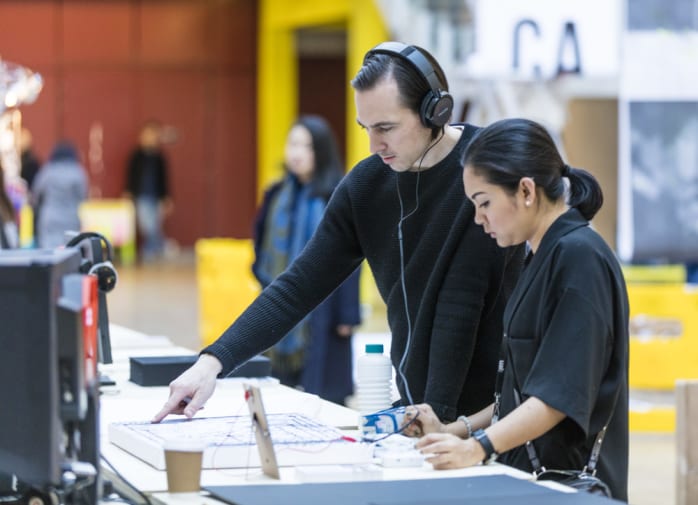 2 colleagues working together on a presentation at a high desk