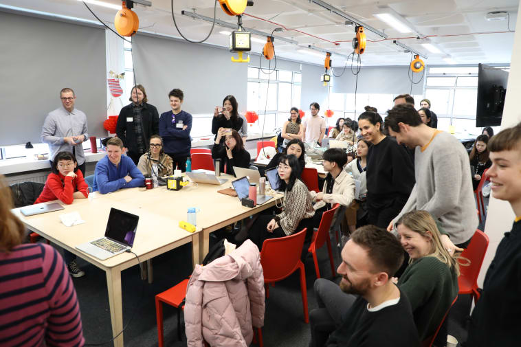 Photo of UX Design students hearing design proposals.