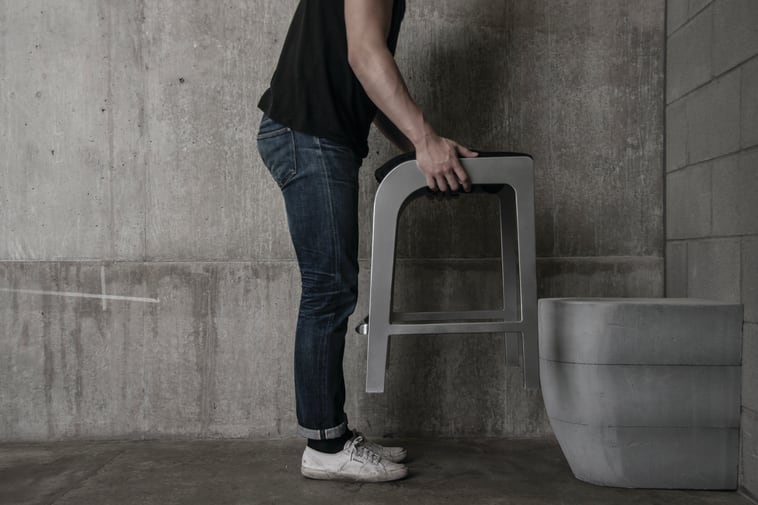 Man holding furniture over toilet