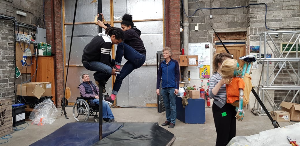 People in a studio practicing a performance