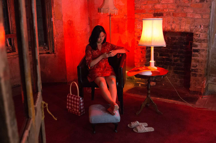 women sat in armchair with red light crafting