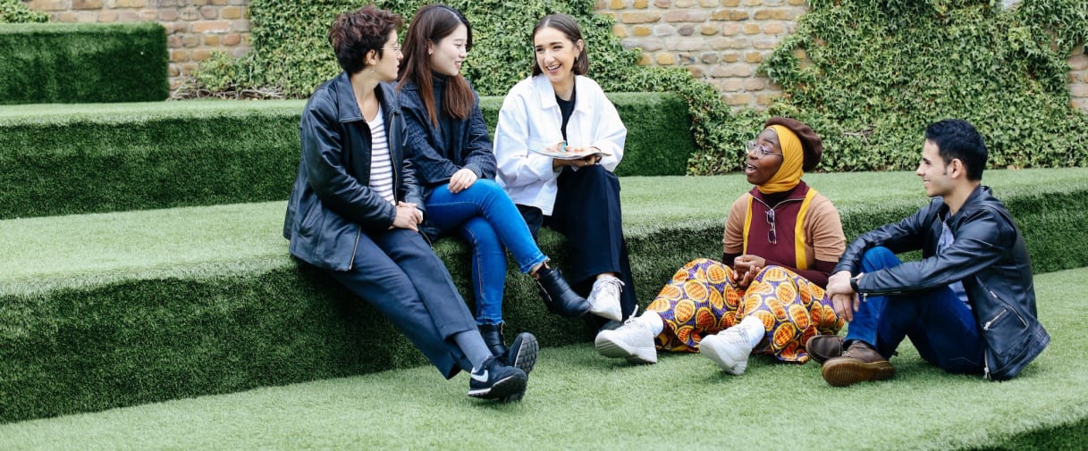 Students sat chatting on astroturf