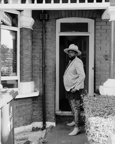 black and white photo of famioly standing on the doorstep of their home
