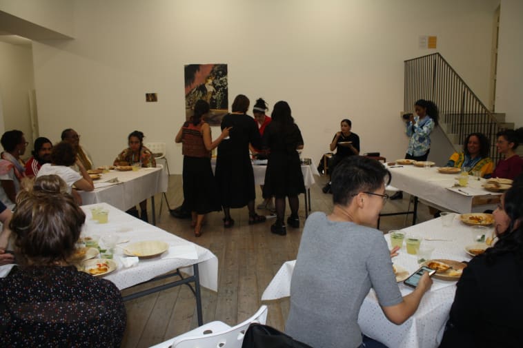 photo of people sharing a meal in the gallery
