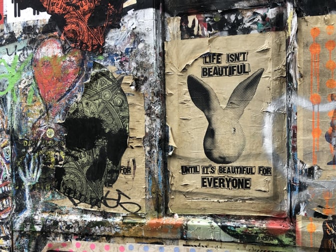 Graffitti and fly poster on urban painted wall