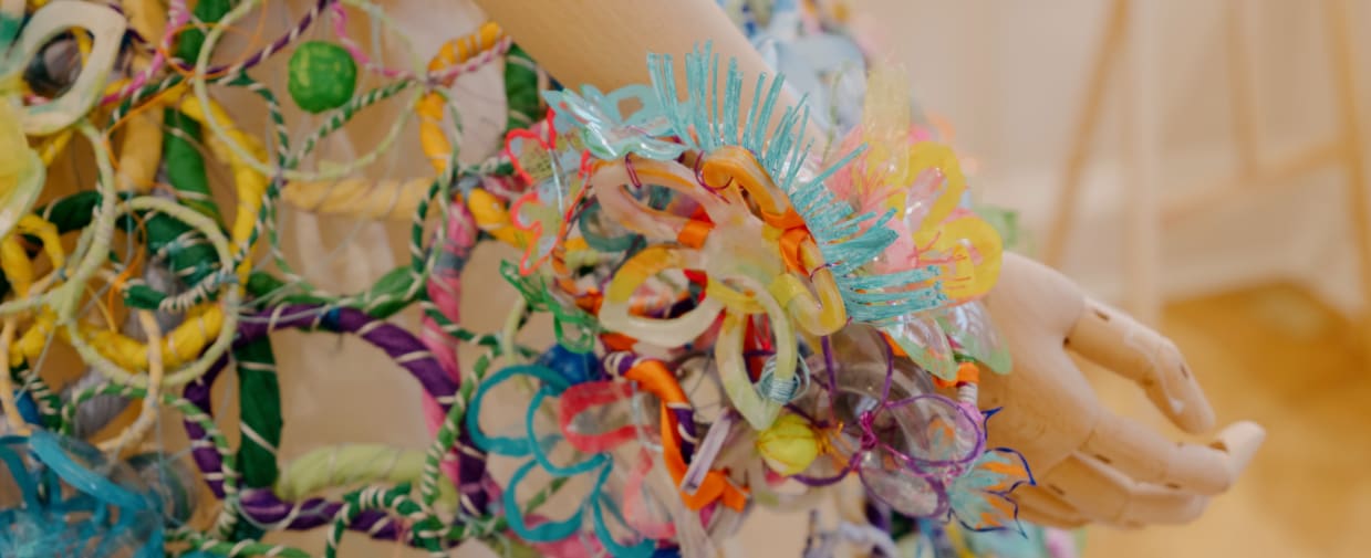 Close up of a costume made of colourful plastic and fabric materials