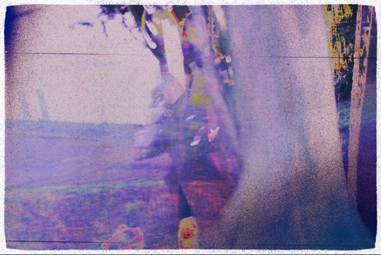 Overexposed purple image of man in woods