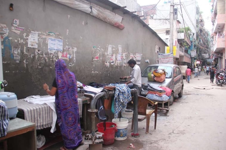 Ironing on the street, Khirki village