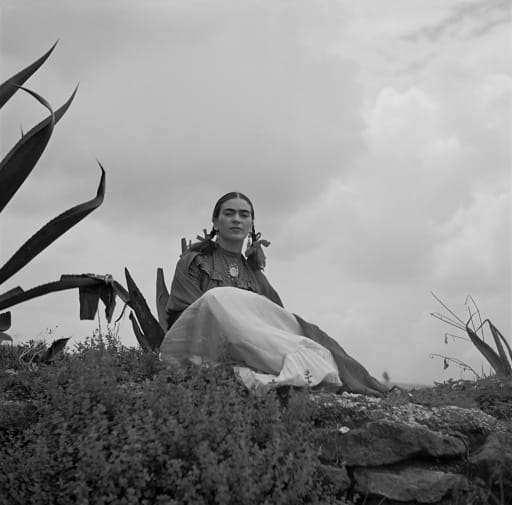 Frida Kahlo seated next to an agave plant, during a photo shoot for Vogue magazine