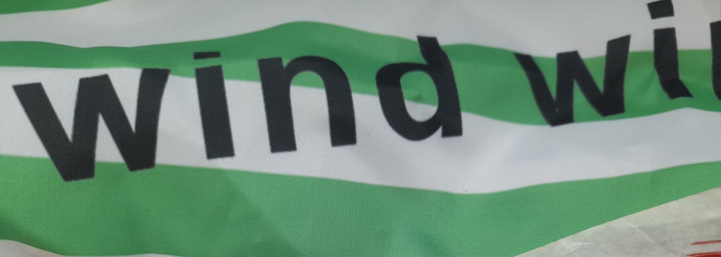Striped green and white fabric with the word 'wind' written on it.